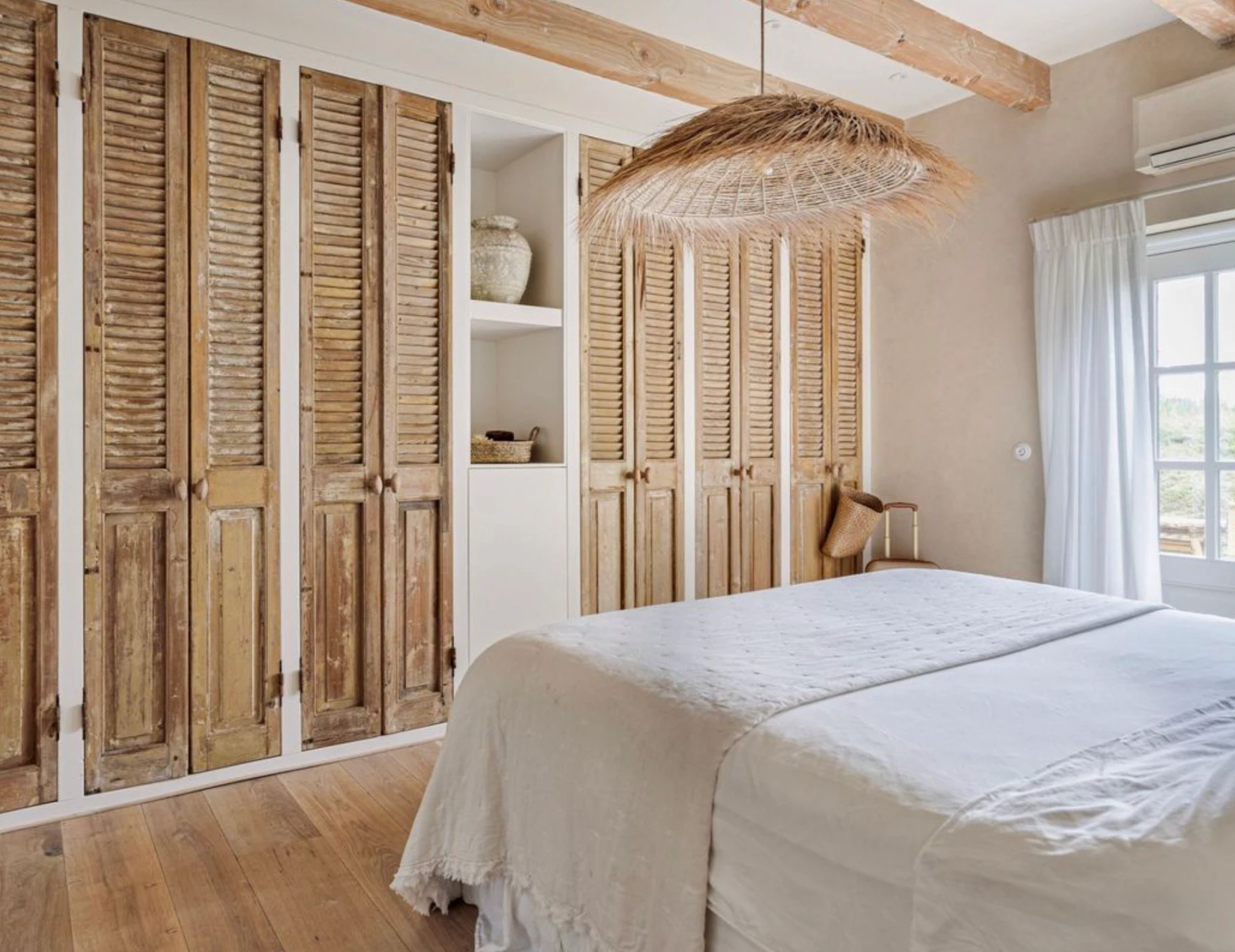 Bedroom with PītasLampas reed ceiling lamp. Handmade, eco-design.